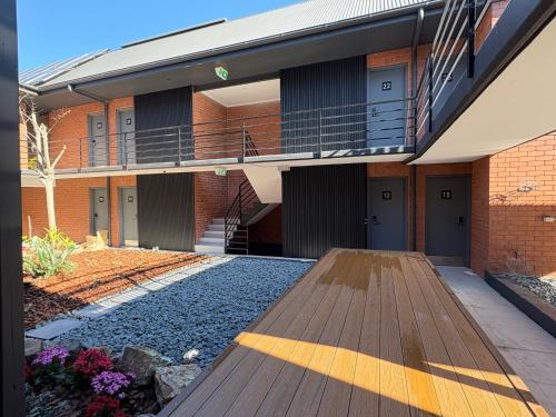 an external view of a school building with a wooden deck at Spring Hill Inn in Brisbane