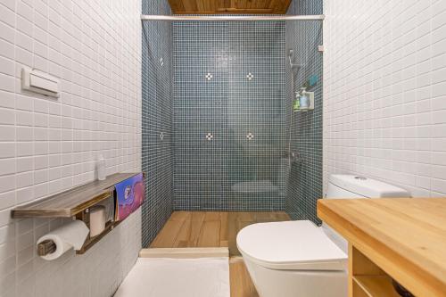 a bathroom with a shower with a toilet and a sink at IsShoNi house in Tainan