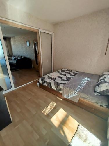 a bedroom with a bed in a room at Galina Apartment in Kŭrdzhali