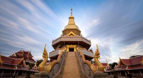 a building with stairs leading up to a tower at Soontree House Hotel in Udon Thani