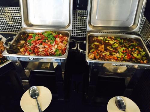 two trays of food sitting on top of a table at The Grace Residence in Surin