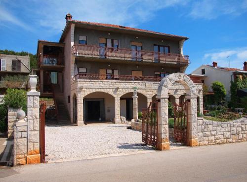 a large house with a gate and an archway at Room Rade in Stari Grad