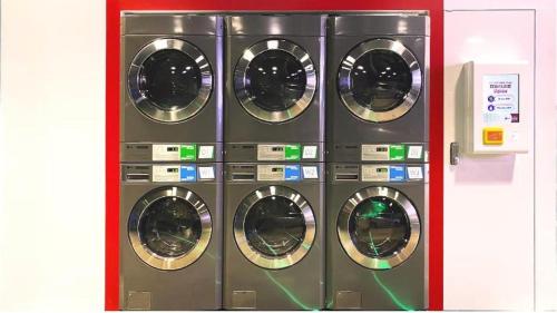 a group of four washing machines in a room at OASIS AVENUE-A GDH HOTEL in Hong Kong