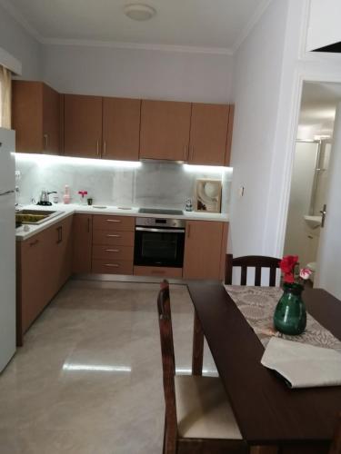 a kitchen with a dining table and a kitchen with a stove at evia mourteri Apartment in Mourteri