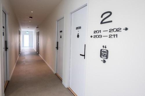 a corridor of an office building with a number on the wall at 777Bliss Hometel in Nakhon Phanom