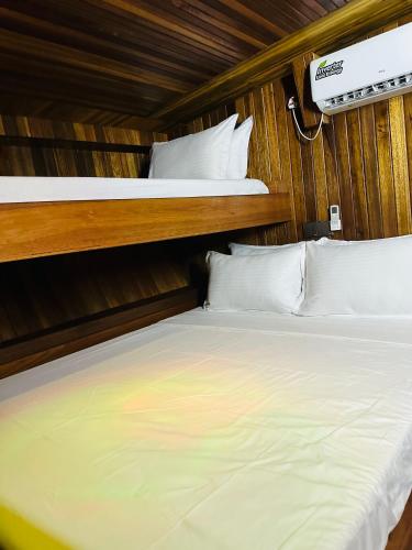a bedroom with two bunk beds with white sheets at Flying Fish in Male City