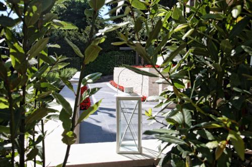 a glass vase sitting on a table between two trees at Hotel Villa Maria in Sirmione