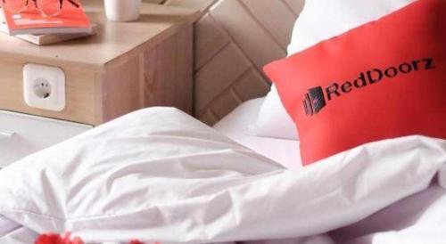 a red laptop sitting on top of a bed at Ha Noi Vang Hotel Hoang Ngan in Hanoi