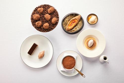 a table with plates and cups of coffee and desserts at Palanga Life Balance SPA Hotel in Palanga