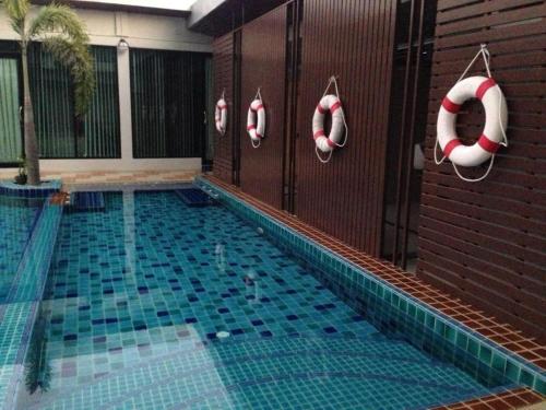 a swimming pool with inflatables on the side of a building at Alvarez Hotel in Buriram