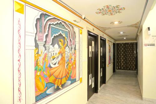 a hallway with paintings on the walls of a building at Hotel Pulse Inn- Near Jaipur Railway Station in Jaipur