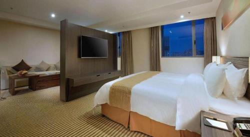 Кровать или кровати в номере Xiamenair Maple Hotel (Xiamen SM City Plaza)