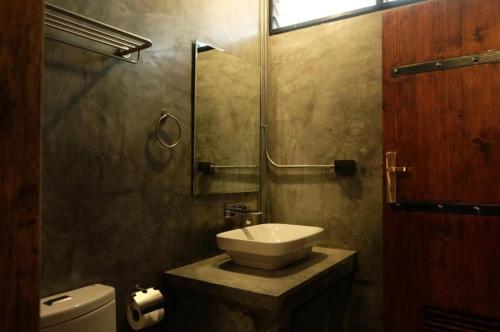 a bathroom with a sink and a toilet at Rider bedroom hostel & cafe in Hua Hin
