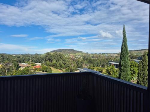 a view from the balcony of a house with a tree at RESIDENTIAL 4 BEDROOM House in Coffs Harbour
