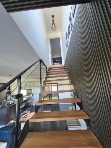 a staircase leading up to a building with wooden benches at RESIDENTIAL 4 BEDROOM House in Coffs Harbour