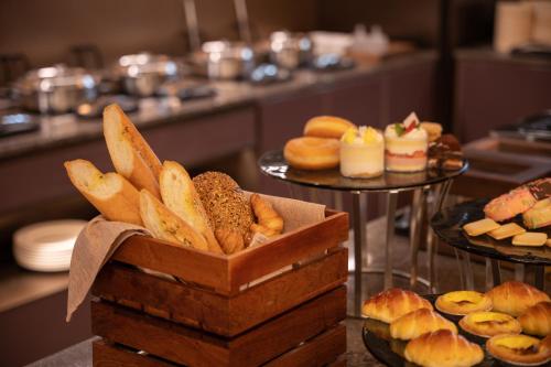 a box of breads and pastries on a table at 北京上地中关村软件园桔子水晶酒店 in Beijing