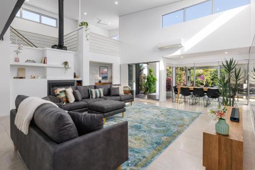 a living room with a couch and a fireplace at Vogue Design Footpath to the beach in Busselton