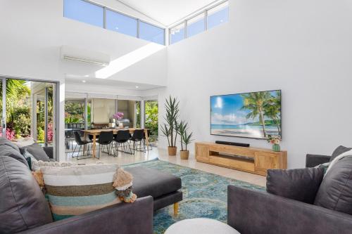 a living room with two couches and a flat screen tv at Vogue Design Footpath to the beach in Busselton
