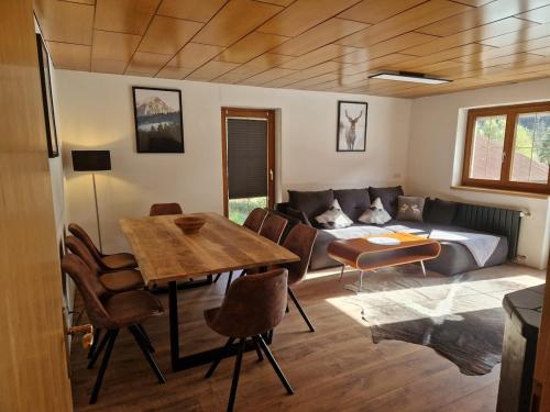 a living room with a couch and a table at Zum schwarzen Hirsch in Dalaas