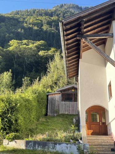 a house with a wooden door on a hill at Zum schwarzen Hirsch in Dalaas
