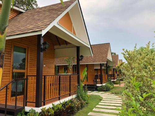 a home with a porch and a deck at Chang Puak Resort Damnoen Saduak in Ratchaburi