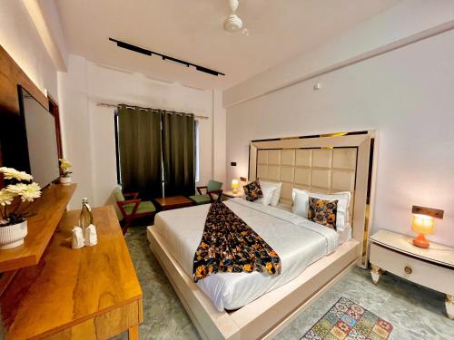 a bedroom with a large bed in a room at Hotel Aura Residency , Haridwar in Haridwār