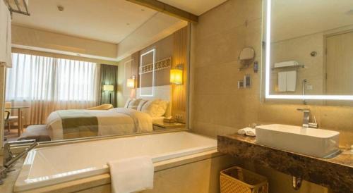 Voodi või voodid majutusasutuse Datong Hotel toas