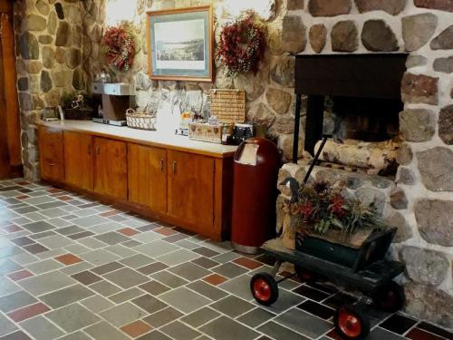 a stone room with a fireplace with a cart in it at Birchwood Inn in Harbor Springs