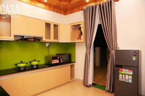 a kitchen with a counter top and a refrigerator at Dalat CASA in Ấp Kim Thạch