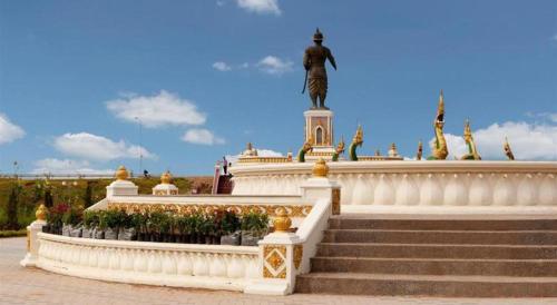 a statue of a man standing on top of a building at Jian Guo Grand Hotel in Vientiane