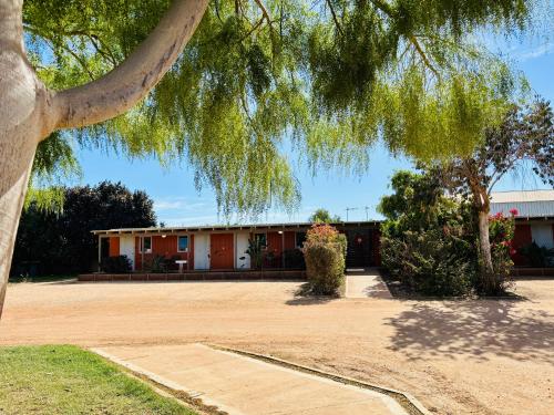 a building with a tree in front of it at Norwesta Lifestyle Park in Carnarvon