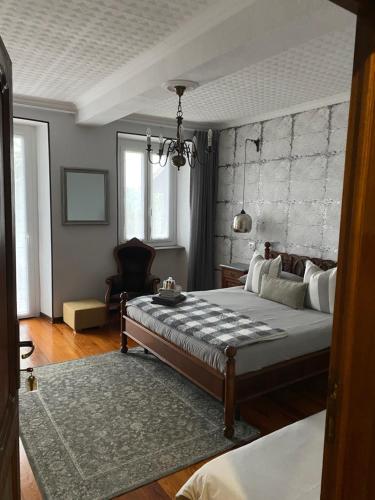 a bedroom with a large bed with a stone wall at La Casa Verde B&B in Trivero