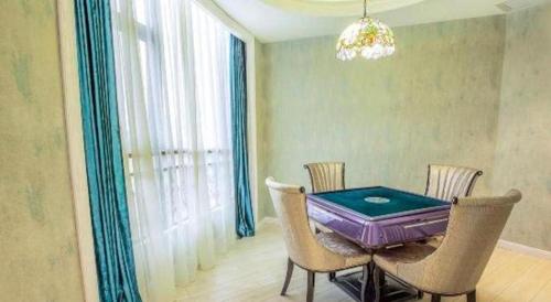 a dining room with a purple table and chairs at Vienna Hotel Guiyang Jiaxiulou Jichang Road in Guiyang