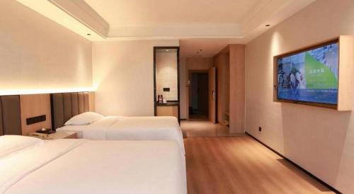 Ένα ή περισσότερα κρεβάτια σε δωμάτιο στο GreenTree Inn Maanshan Hanshan District Jiuwu Square Hotel