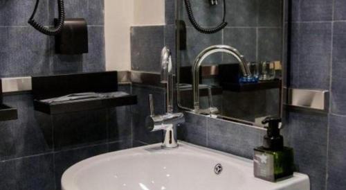 a bathroom with a sink with a faucet at YUNIK-Shanghai Zhongshan Park Yan'an Xi Road in Shanghai