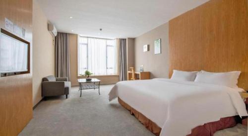 a large white bed in a hotel room at The Art Hotel in Shenzhen