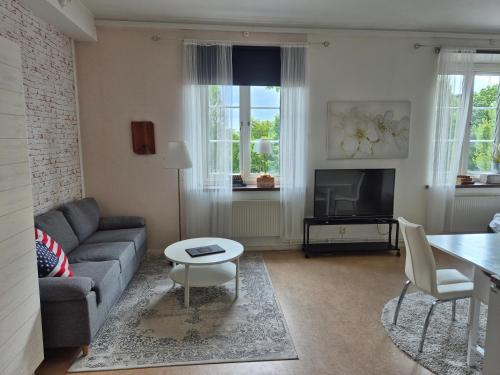 a living room with a couch and a table at Hotel New Bed in Oskarshamn