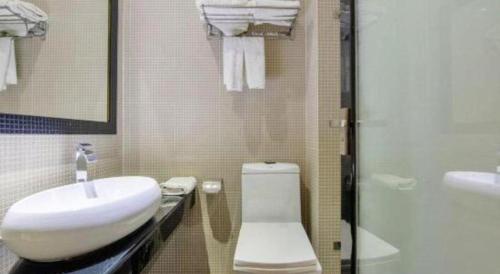 a bathroom with a sink and a toilet and a shower at The Art Hotel in Shenzhen