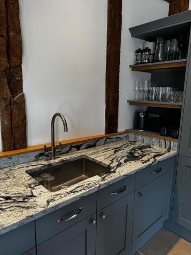 a kitchen with a sink and a counter top at The Old Ironhouse in Hungerford