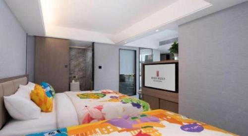 a bedroom with a bed and a flat screen tv at Nanning Prince Hotel in Nanning