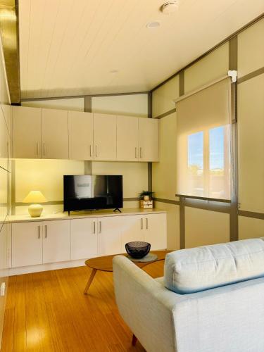 a living room with a couch and a table at Norwesta Lifestyle Park in Carnarvon