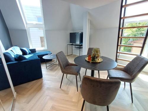 a living room with a table and chairs and a couch at Luise LuXe Suites in Tallinn