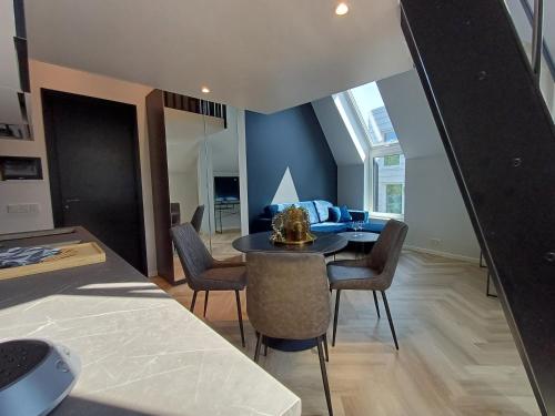 a living room with a table and chairs and a couch at Luise LuXe Suites in Tallinn