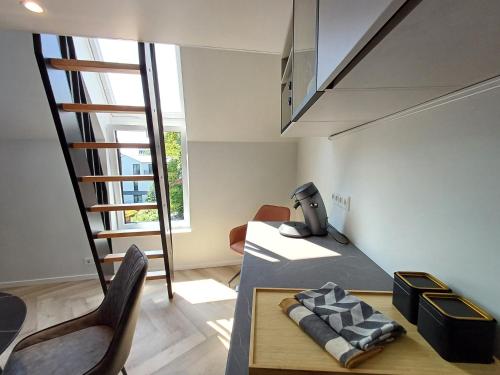 a room with a staircase and a table and chairs at Luise LuXe Suites in Tallinn