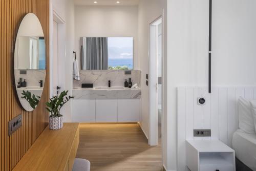 a bathroom with a sink and a mirror at Zeus Luxury Villas in Elounda