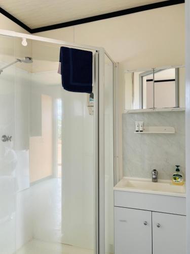 a white bathroom with a sink and a shower at Norwesta Lifestyle Park in Carnarvon