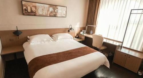 Ένα ή περισσότερα κρεβάτια σε δωμάτιο στο Jinjiang Inn Select Xuzhou Suining Middle Yuanfu Road