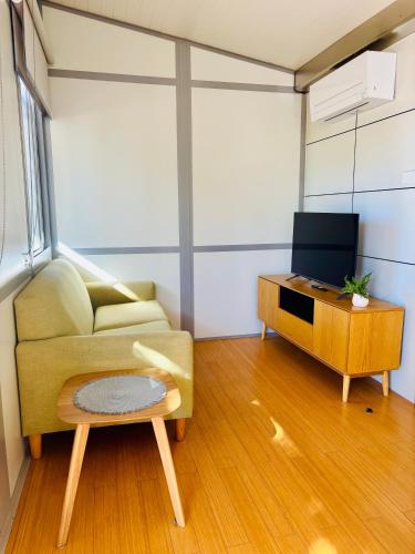 a living room with a couch and a tv at Norwesta Lifestyle Park in Carnarvon