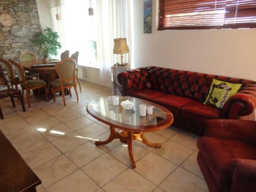 a living room with a red couch and a table at BSG Apartments in Selfoss