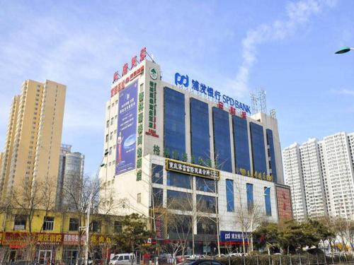a building with a sign on the top of it at GreenTree Inn Taiyuan PinGYAng Road Business Hotel in Taiyuan